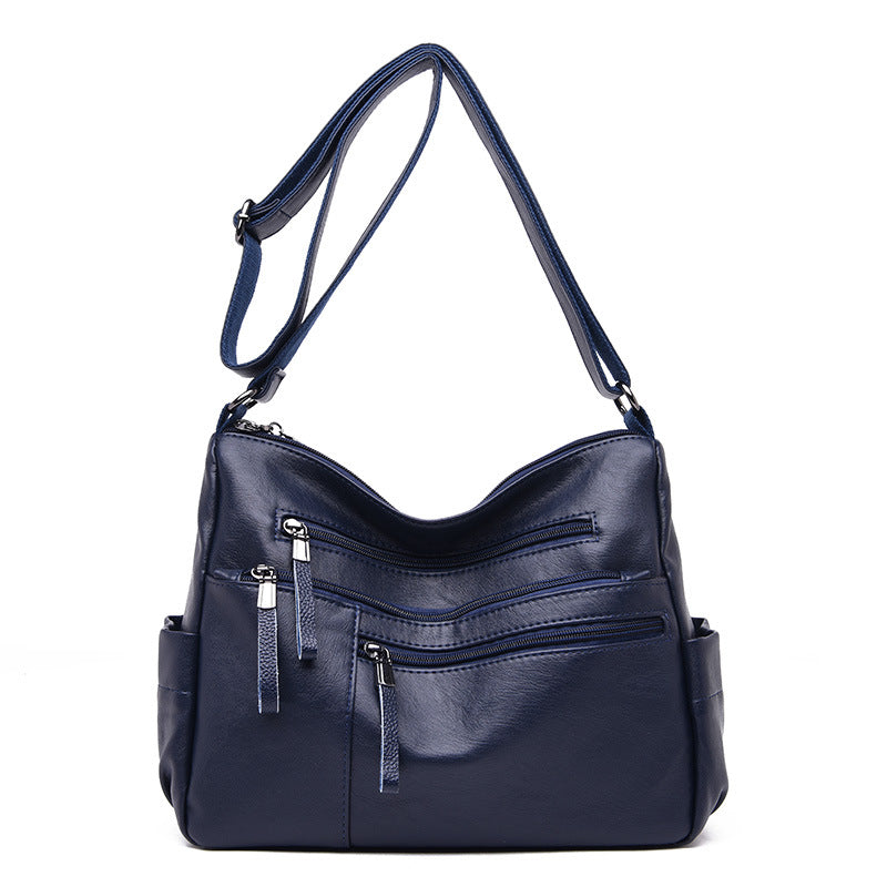 A stylish PU leather women's messenger bag in a horizontal square shape, featuring a zipper opening and a soft polyester cotton lining.