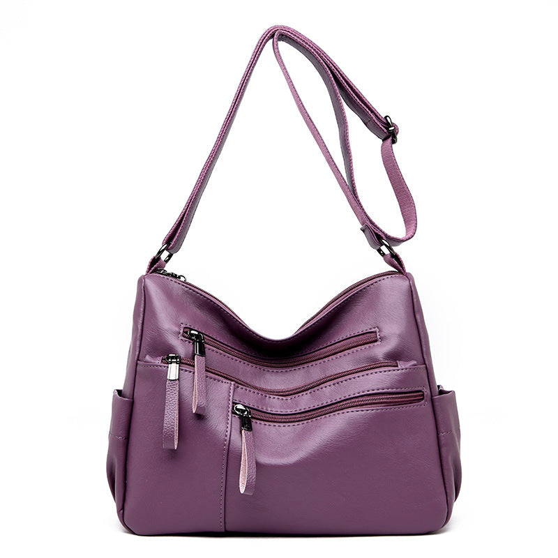 A stylish PU leather women's messenger bag in a horizontal square shape, featuring a zipper opening and a soft polyester cotton lining.