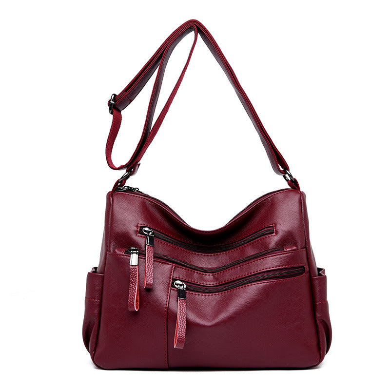A stylish PU leather women's messenger bag in a horizontal square shape, featuring a zipper opening and a soft polyester cotton lining.