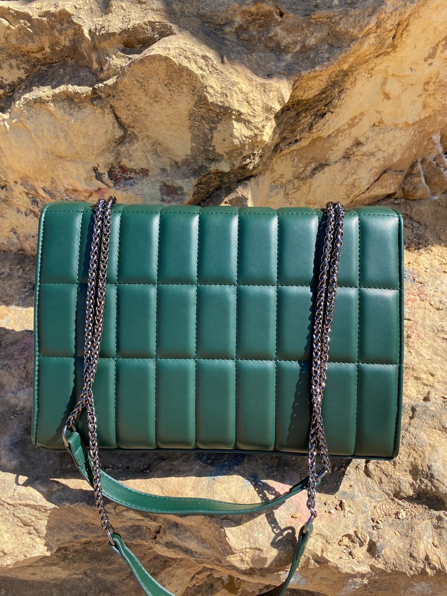 Quilted chain strap shoulder bag in green, pink, and blue colors with a stylish design and metal closure.