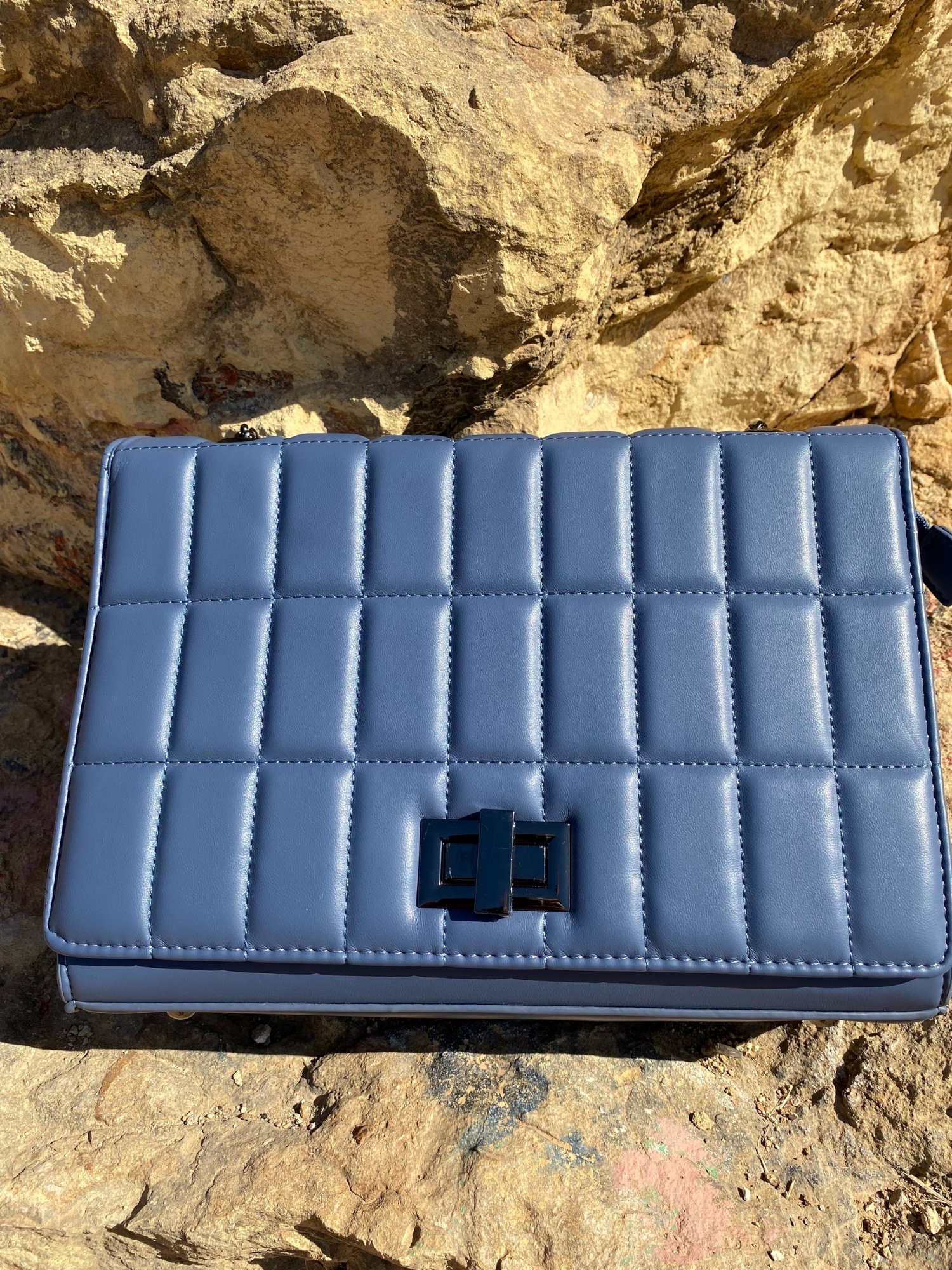 Quilted chain strap shoulder bag in green, pink, and blue colors with a stylish design and metal closure.