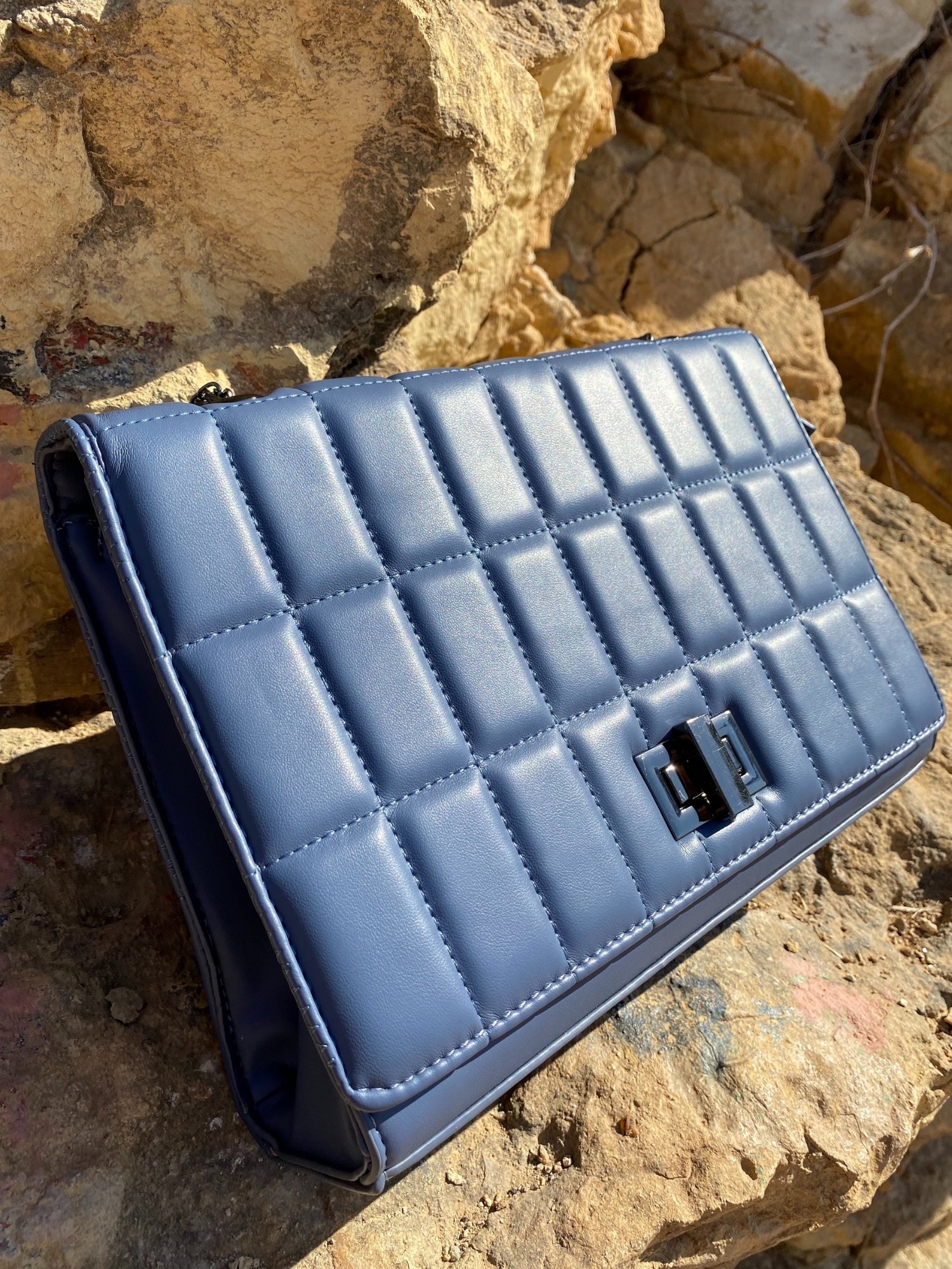 Quilted chain strap shoulder bag in green, pink, and blue colors with a stylish design and metal closure.