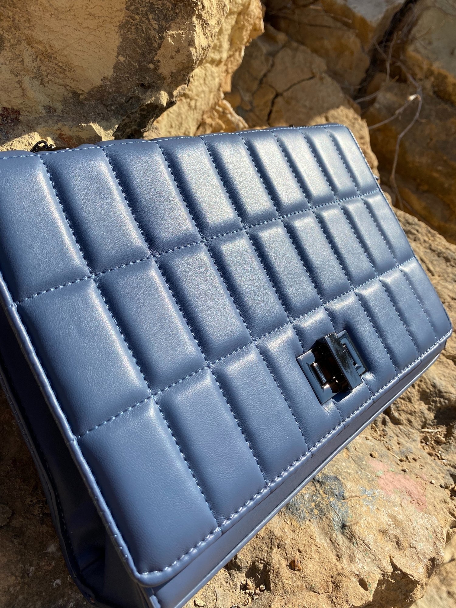 Quilted chain strap shoulder bag in green, pink, and blue colors with a stylish design and metal closure.