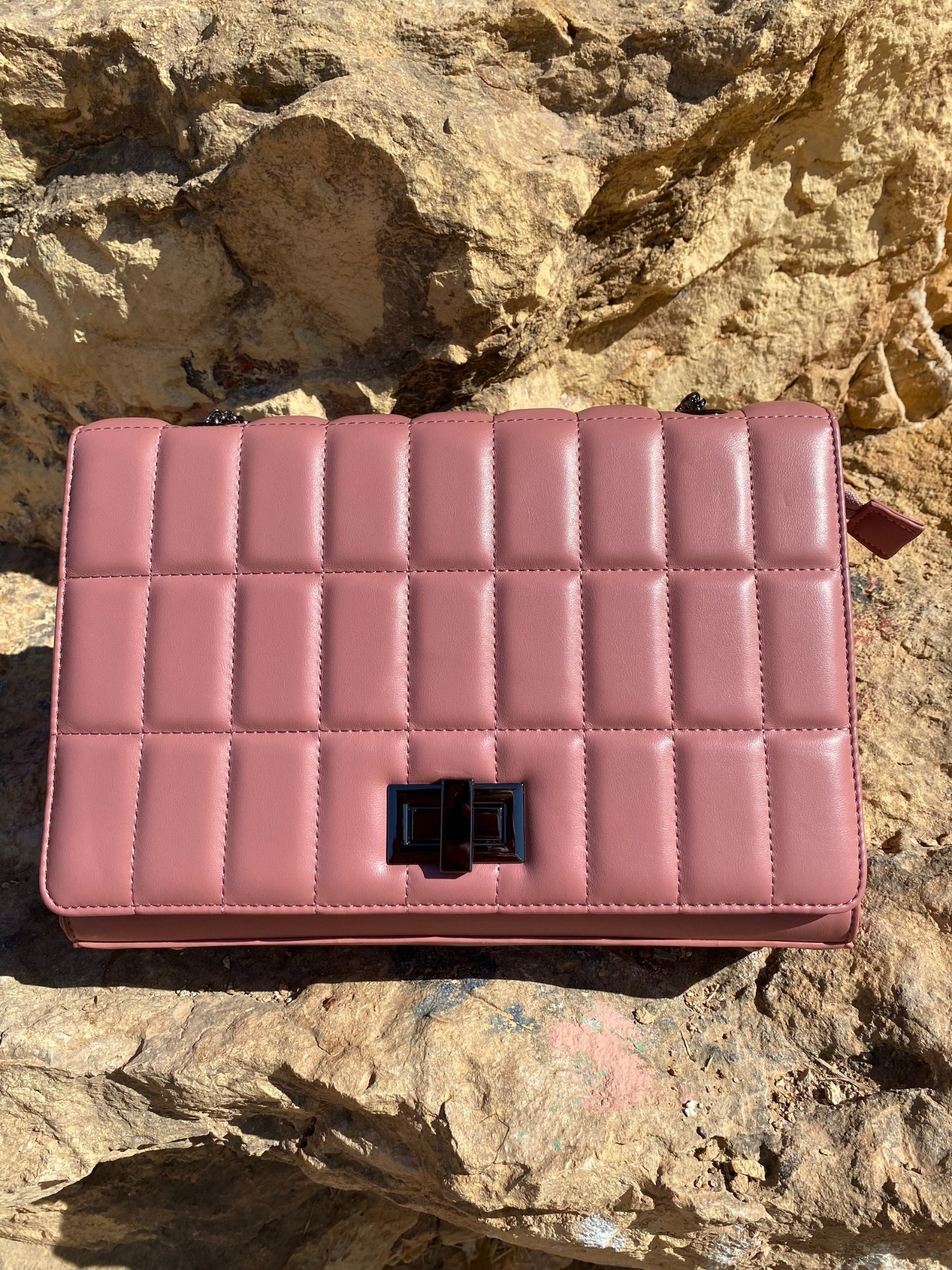 Quilted chain strap shoulder bag in green, pink, and blue colors with a stylish design and metal closure.