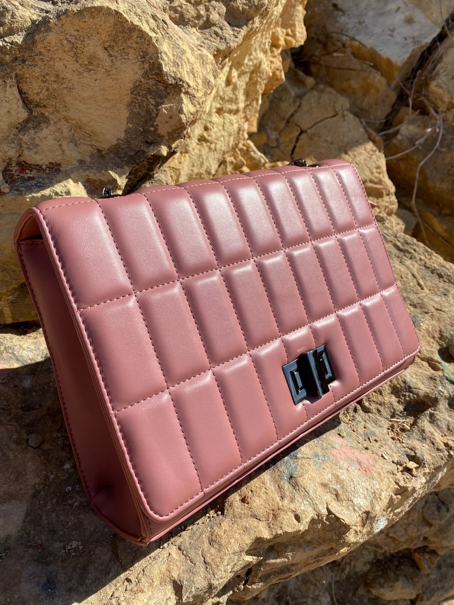 Quilted chain strap shoulder bag in green, pink, and blue colors with a stylish design and metal closure.