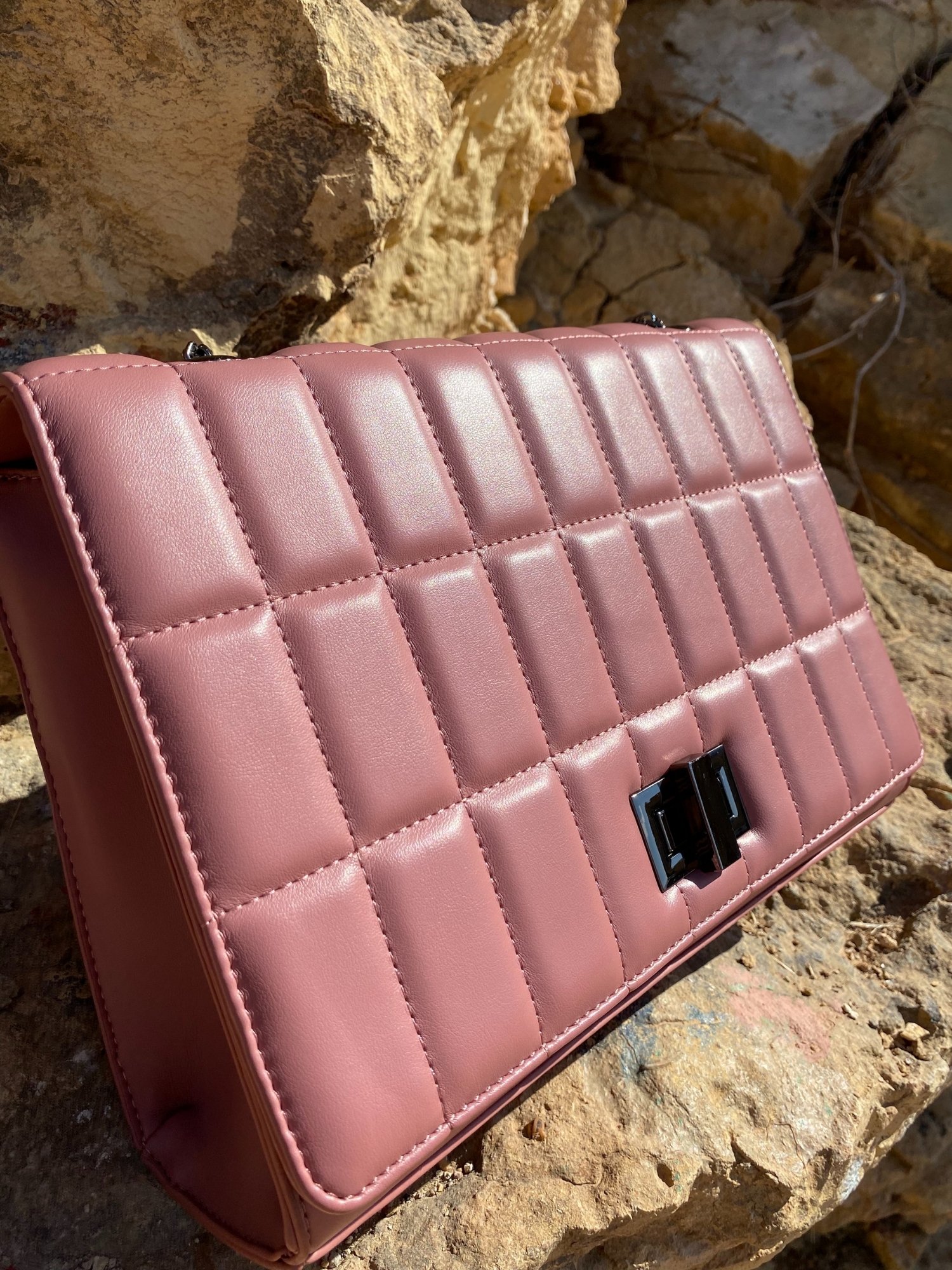 Quilted chain strap shoulder bag in green, pink, and blue colors with a stylish design and metal closure.