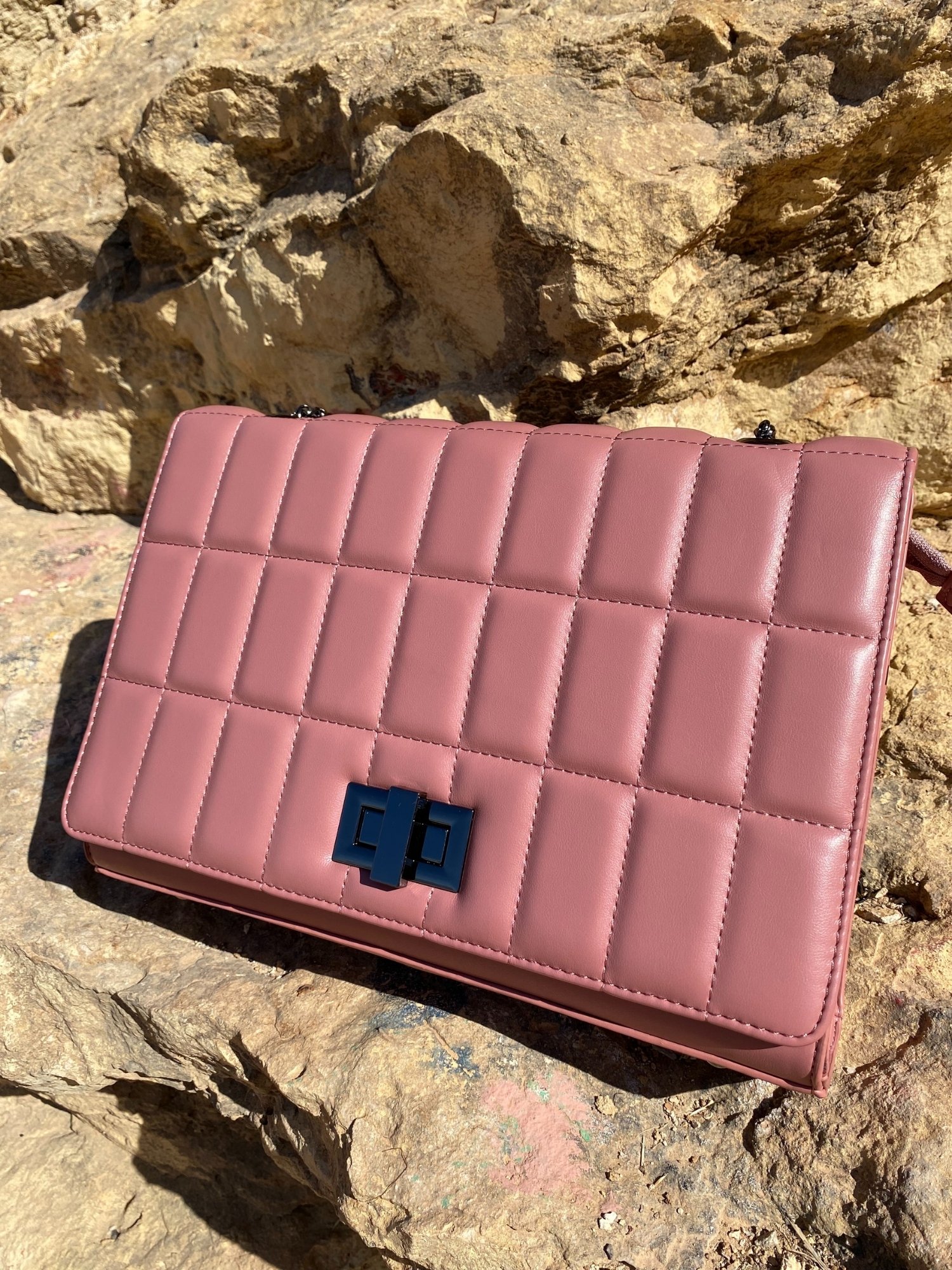 Quilted chain strap shoulder bag in green, pink, and blue colors with a stylish design and metal closure.