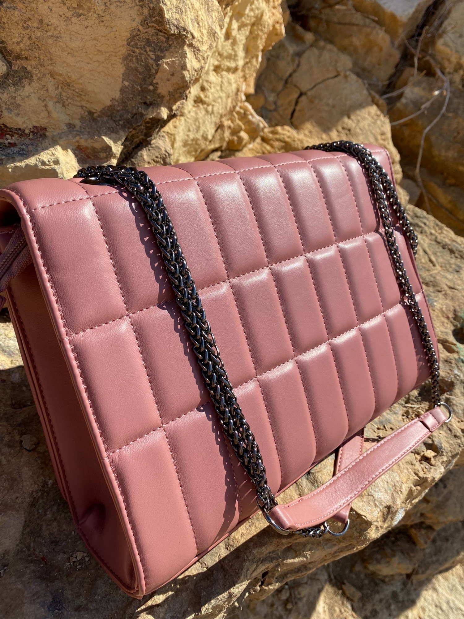 Quilted chain strap shoulder bag in green, pink, and blue colors with a stylish design and metal closure.