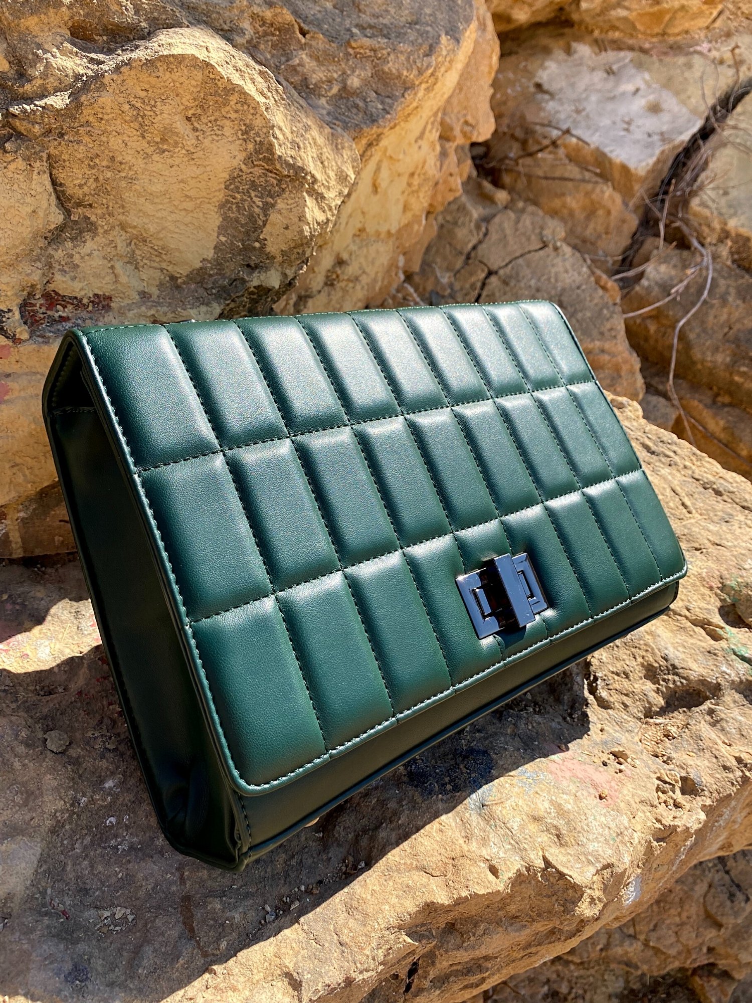 Quilted chain strap shoulder bag in green, pink, and blue colors with a stylish design and metal closure.