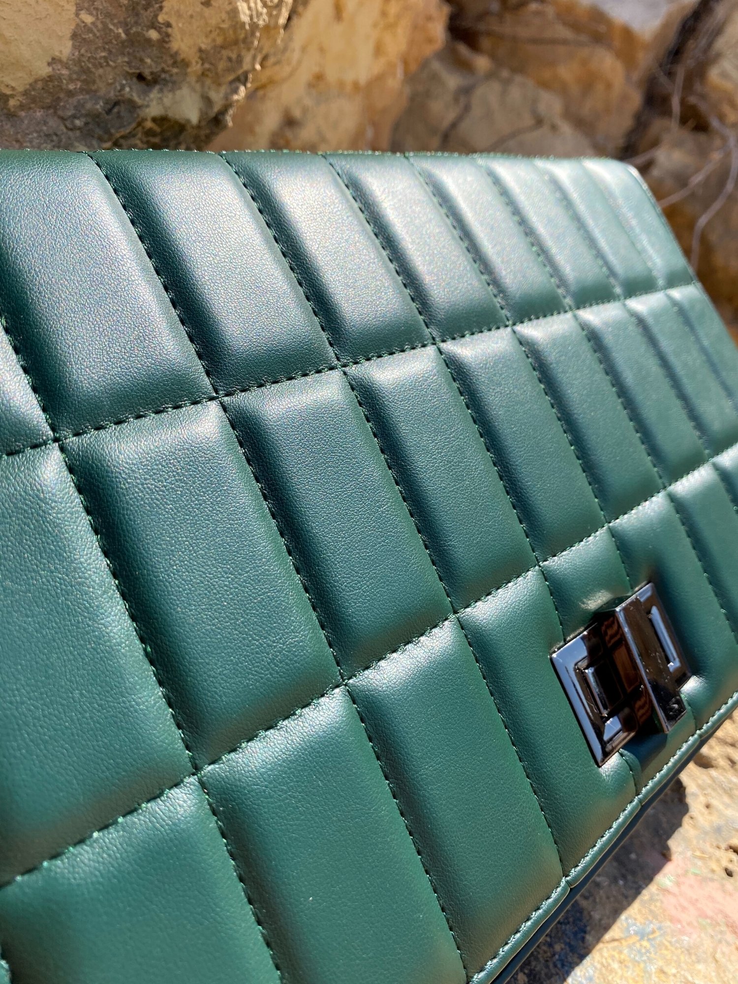 Quilted chain strap shoulder bag in green, pink, and blue colors with a stylish design and metal closure.