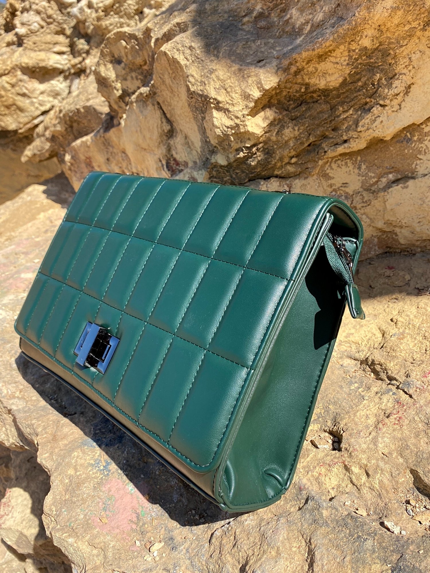 Quilted chain strap shoulder bag in green, pink, and blue colors with a stylish design and metal closure.