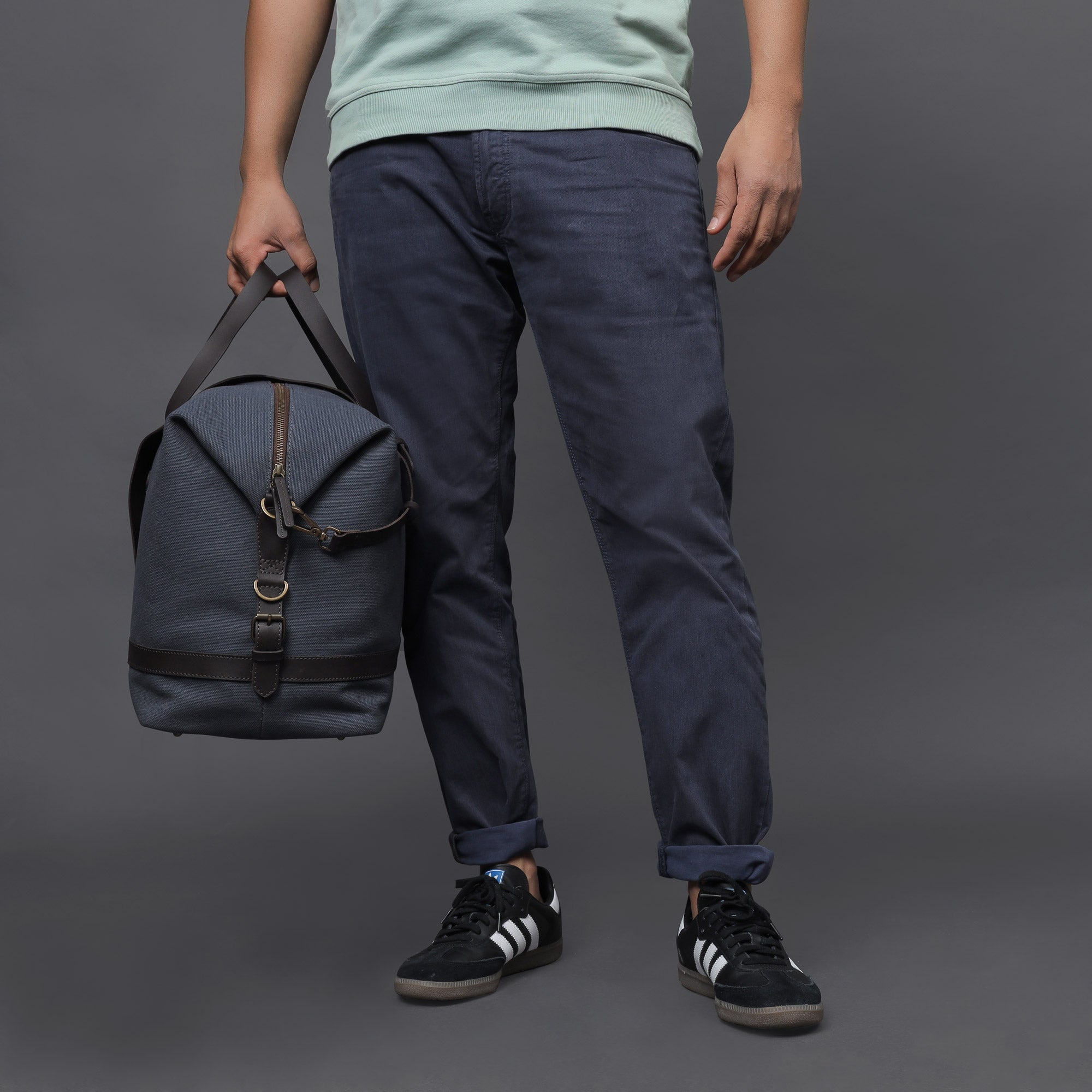 Runway Canvas Travel Bag featuring durable cotton canvas, adjustable leather strap, and vintage buckles.