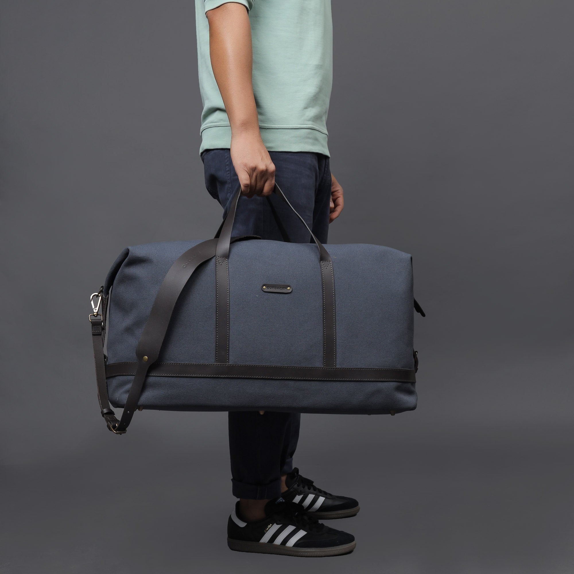 Runway Canvas Travel Bag featuring durable cotton canvas, adjustable leather strap, and vintage buckles.