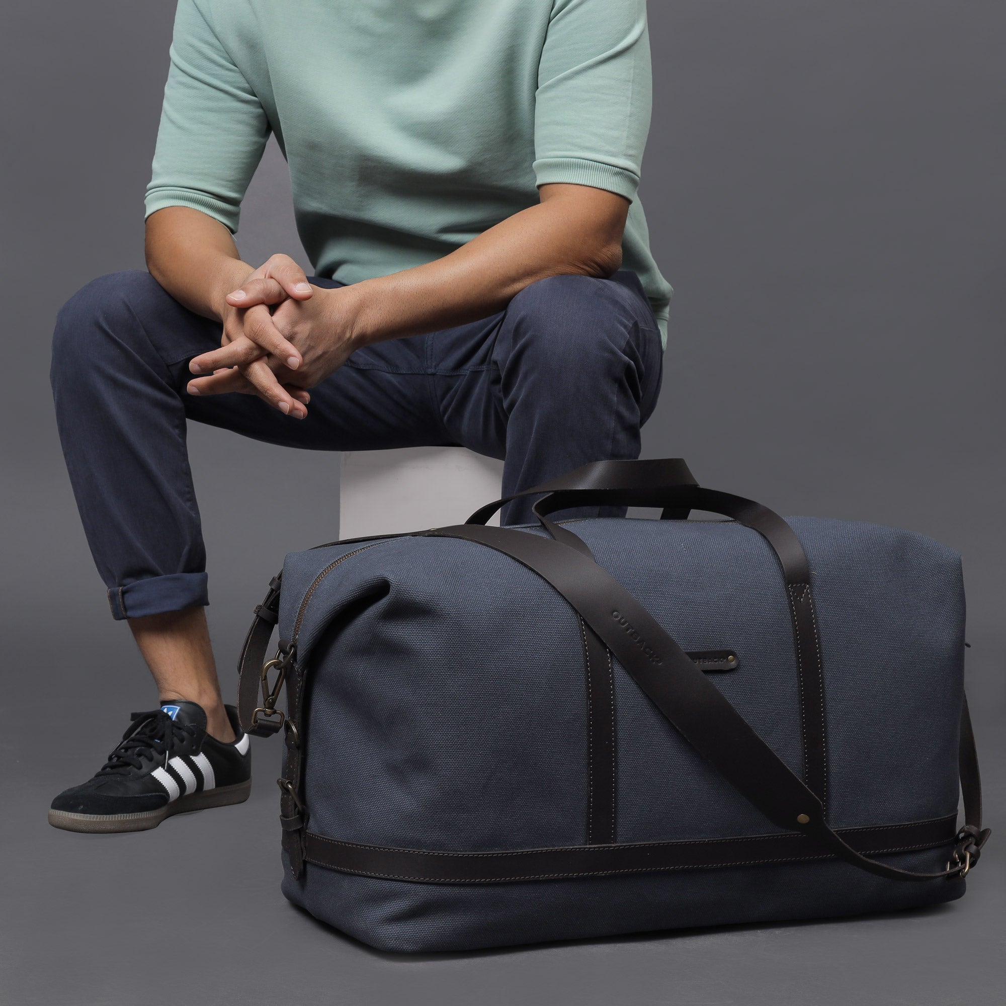 Runway Canvas Travel Bag featuring durable cotton canvas, adjustable leather strap, and vintage buckles.