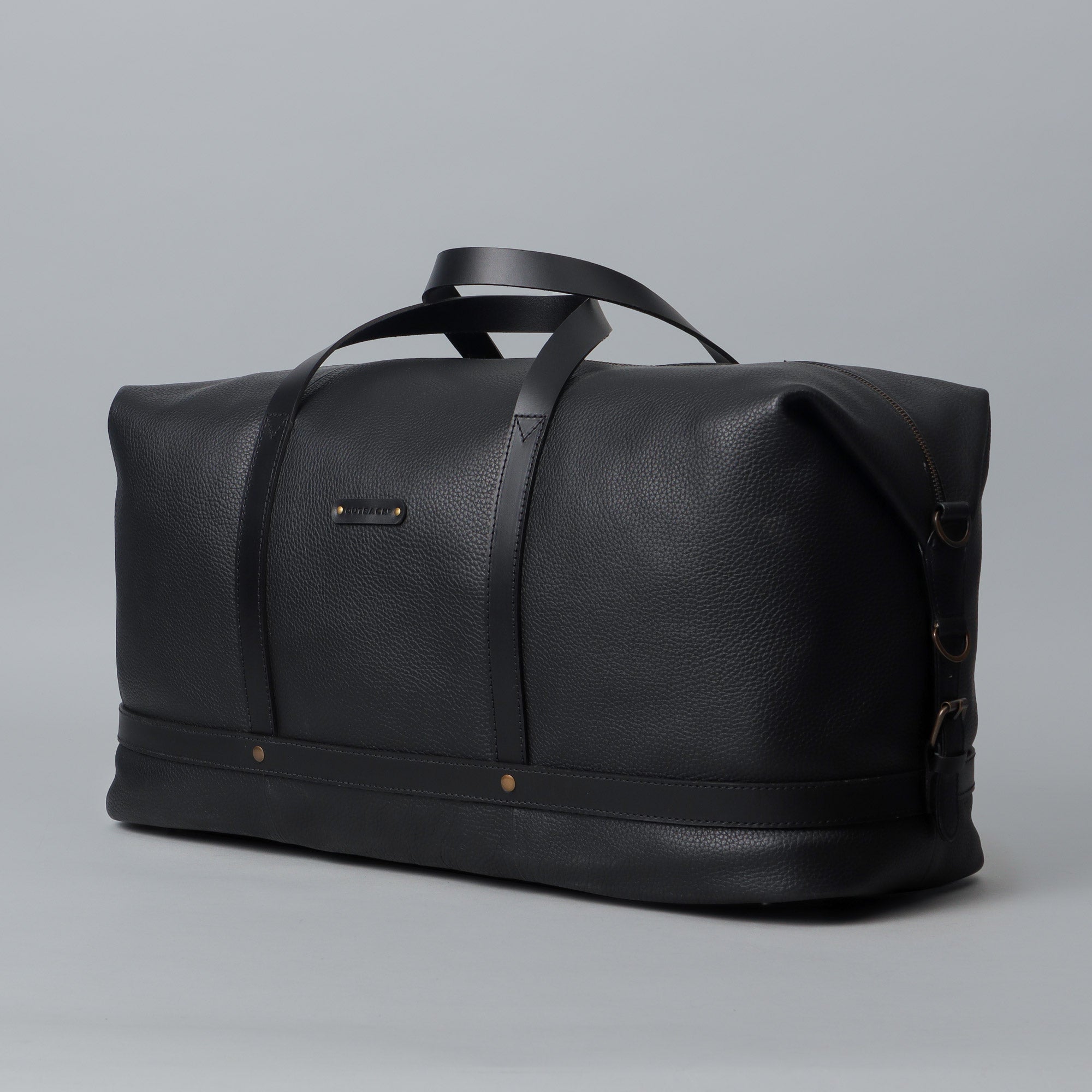 Runway Leather Travel Bag made from premium full grain leather with vintage buckles and adjustable strap, showcasing its spacious interior and elegant design.