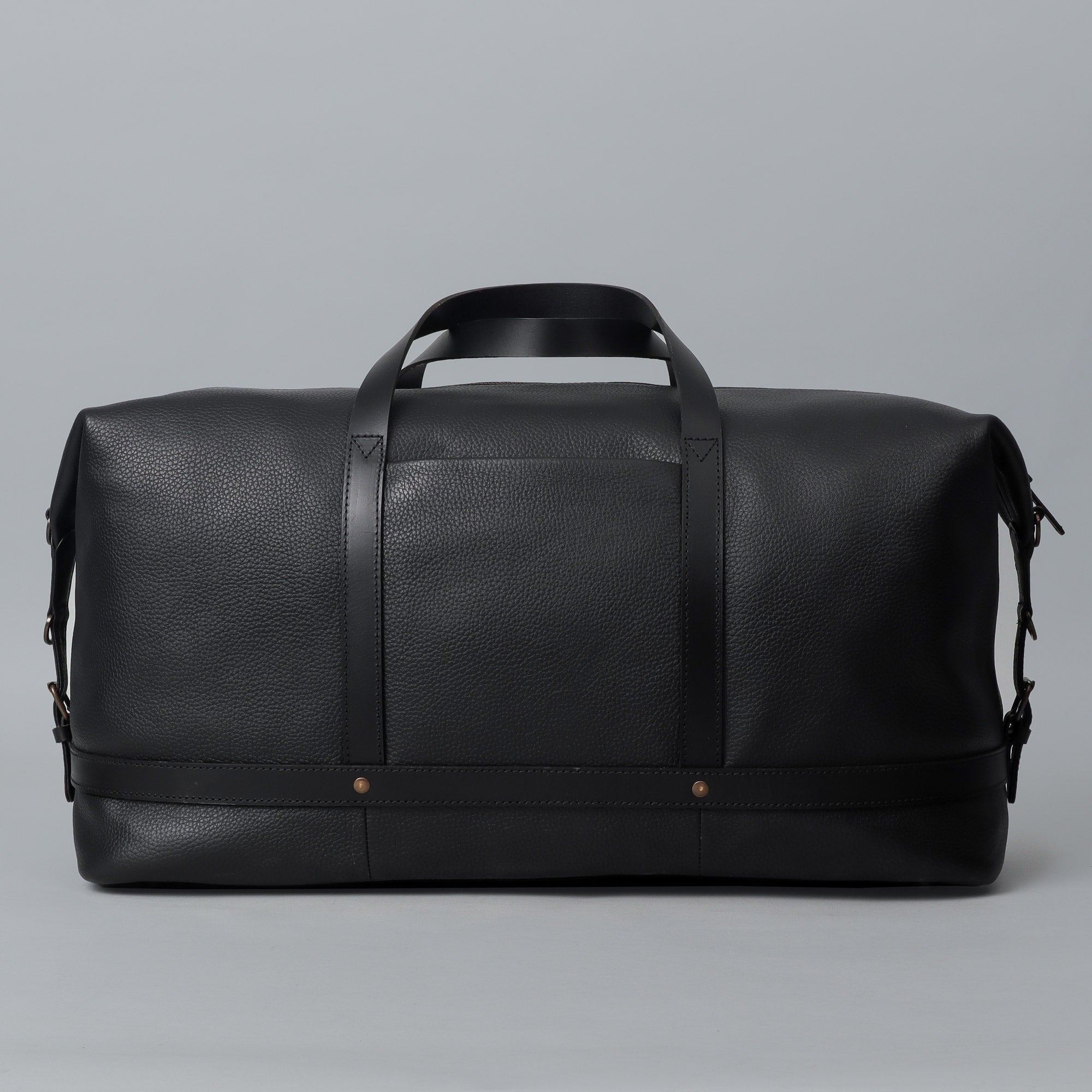 Runway Leather Travel Bag made from premium full grain leather with vintage buckles and adjustable strap, showcasing its spacious interior and elegant design.
