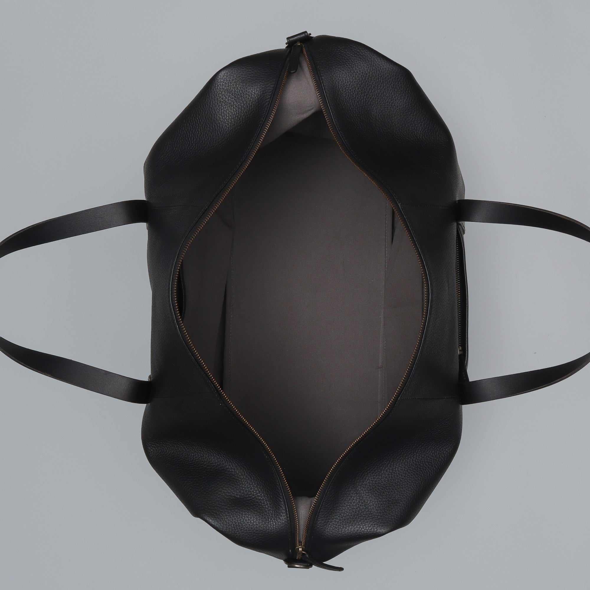 Runway Leather Travel Bag made from premium full grain leather with vintage buckles and adjustable strap, showcasing its spacious interior and elegant design.