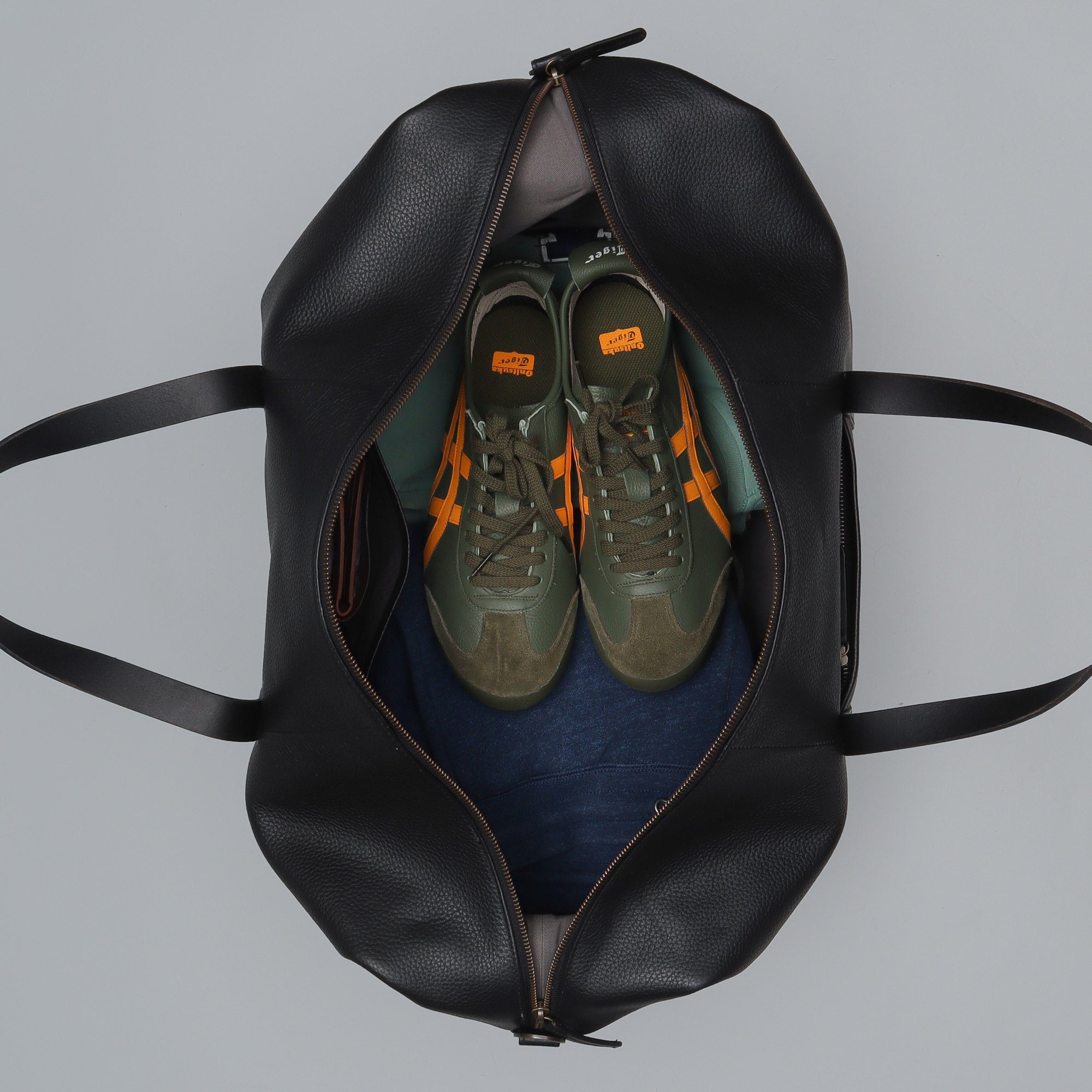 Runway Leather Travel Bag made from premium full grain leather with vintage buckles and adjustable strap, showcasing its spacious interior and elegant design.