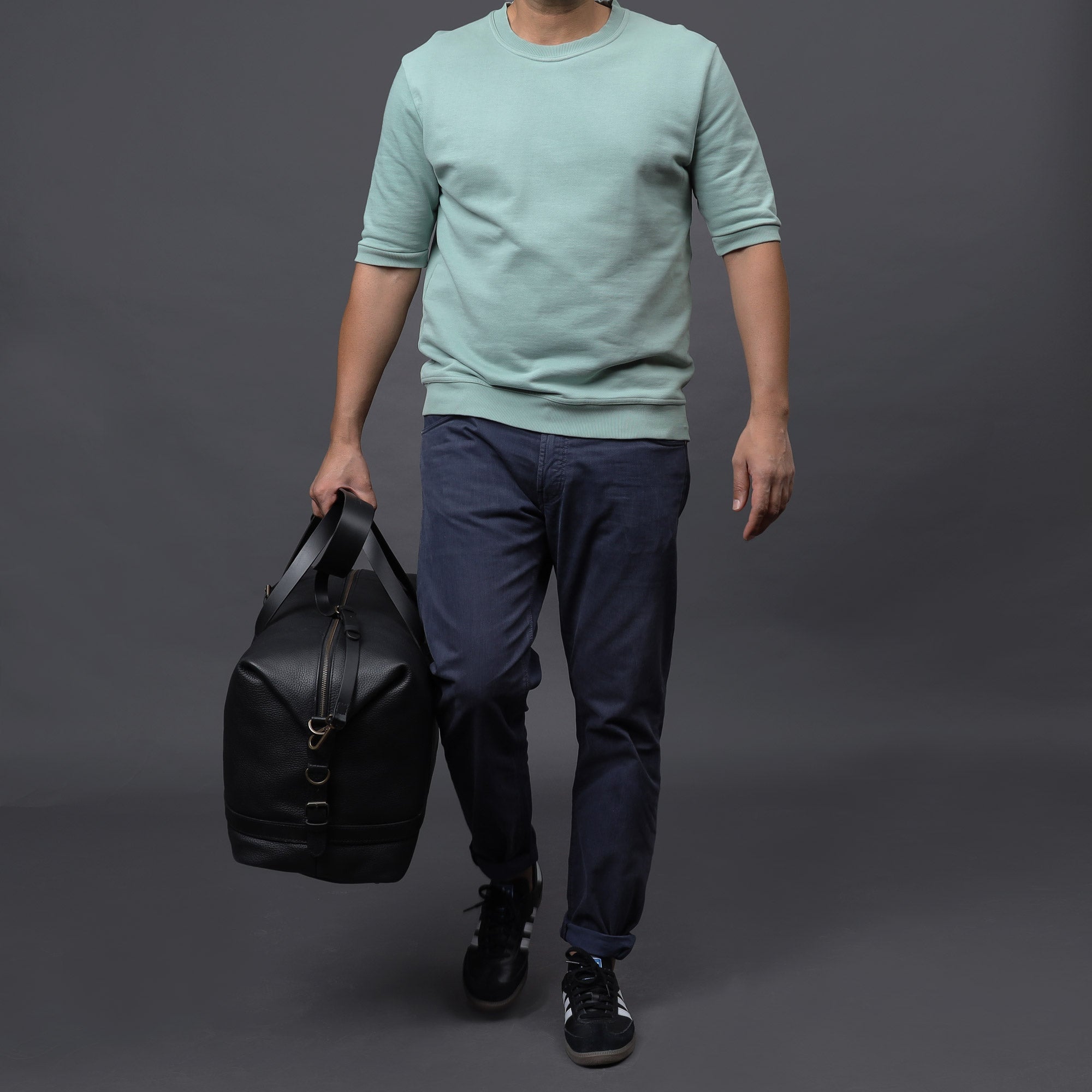 Runway Leather Travel Bag made from premium full grain leather with vintage buckles and adjustable strap, showcasing its spacious interior and elegant design.