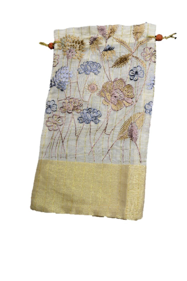 A beautifully handcrafted silk gift bag from Varanasi, India, showcasing intricate stitching and vibrant colors.