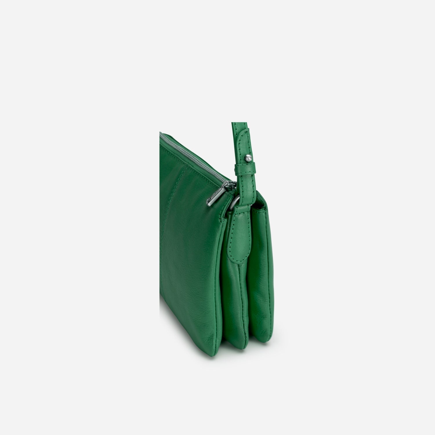 Slim Ladies Leather Crossbody handbag in Spring Basil color, showcasing its chic design and adjustable strap.