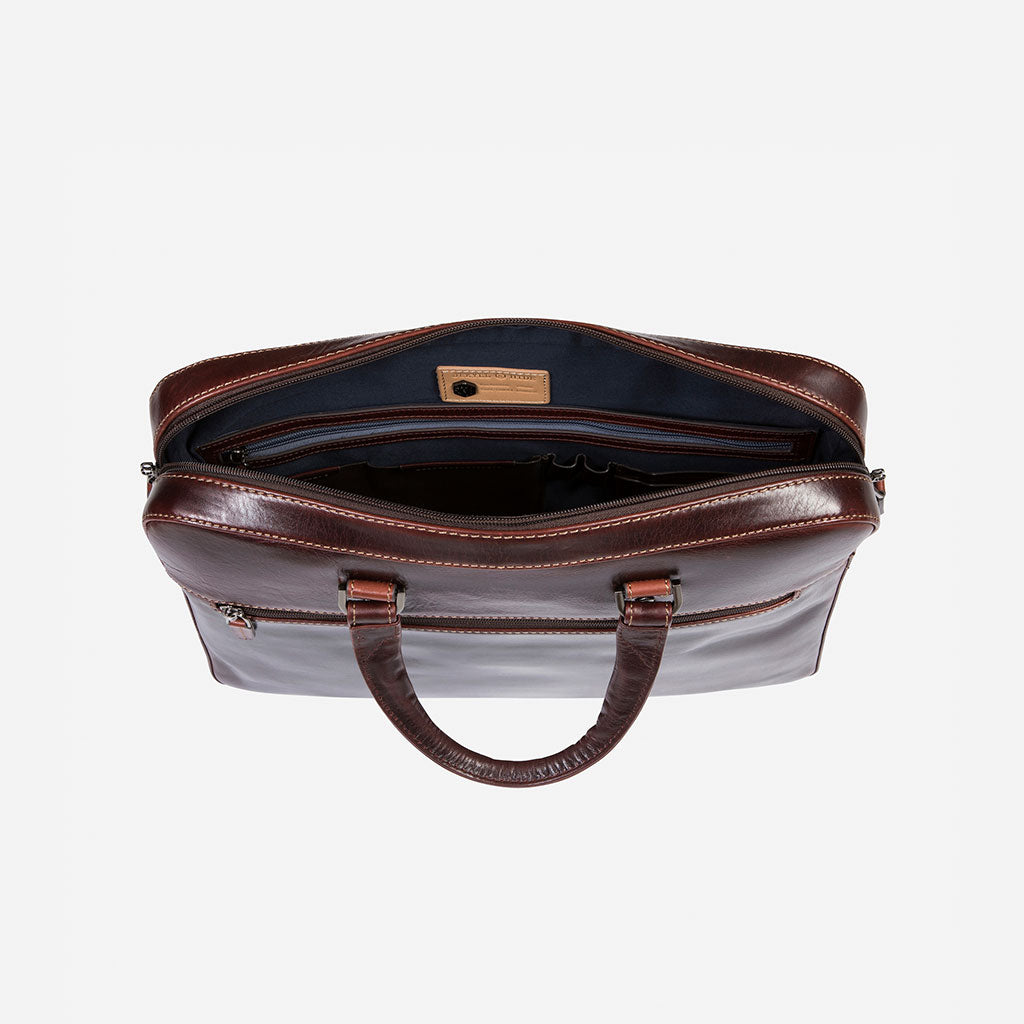 Slim Zip Top Briefcase in Tobacco leather, showcasing its elegant design and spacious zippered compartment.