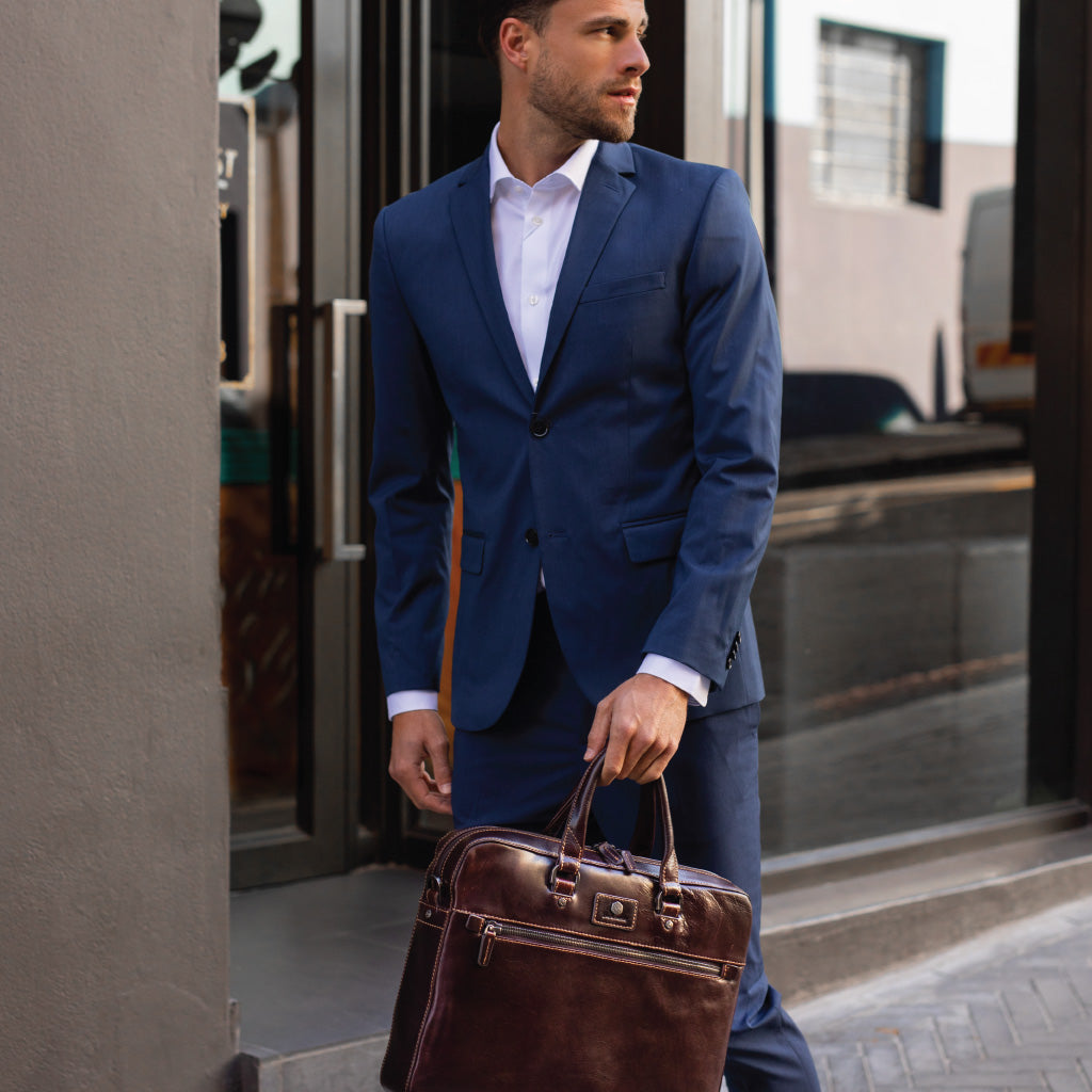 Slim Zip Top Briefcase in Tobacco leather, showcasing its elegant design and spacious zippered compartment.