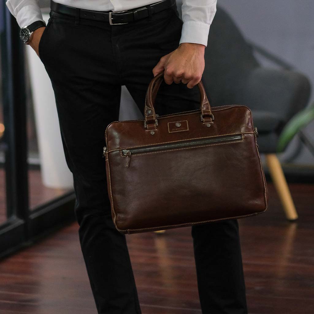 Slim Zip Top Briefcase in Tobacco leather, showcasing its elegant design and spacious zippered compartment.
