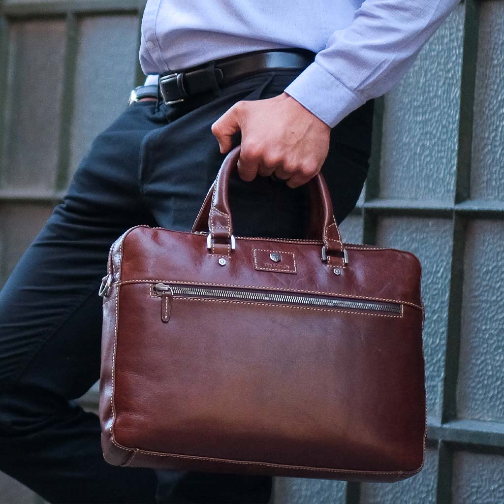 Slim Zip Top Briefcase in Tobacco leather, showcasing its elegant design and spacious zippered compartment.