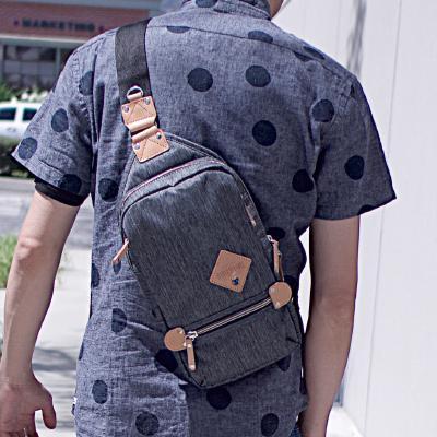 SLING PACK ELEMENT in three colors, showcasing its sleek design and multiple pockets.