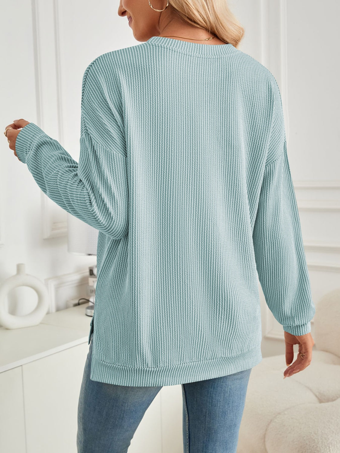 A stylish Slit Round Neck Long Sleeve Sweatshirt featuring a modern slit design, made from a soft and stretchy fabric blend.