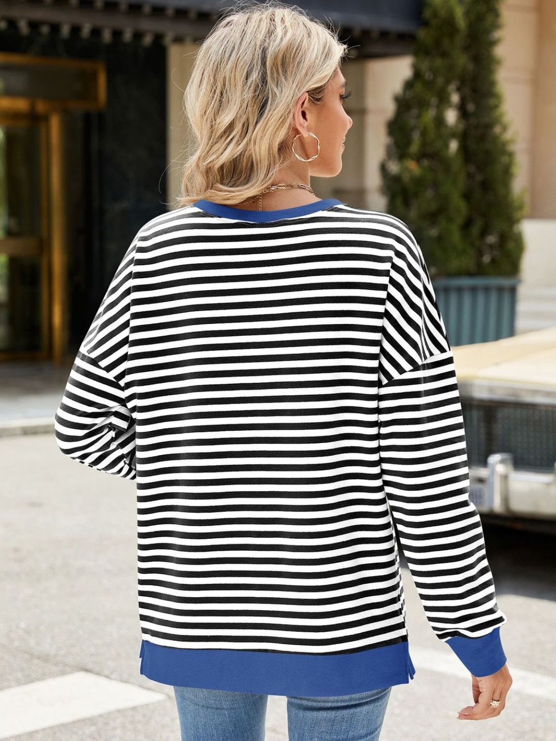 A stylish Slit Striped Round Neck Long Sleeve Sweatshirt featuring a trendy slit design, soft fabric, and available in various sizes.