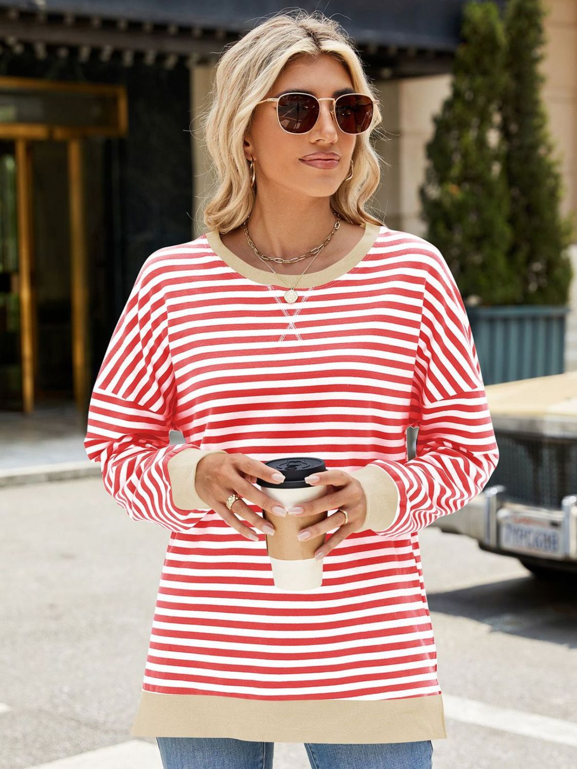 A stylish Slit Striped Round Neck Long Sleeve Sweatshirt featuring a trendy slit design, soft fabric, and available in various sizes.