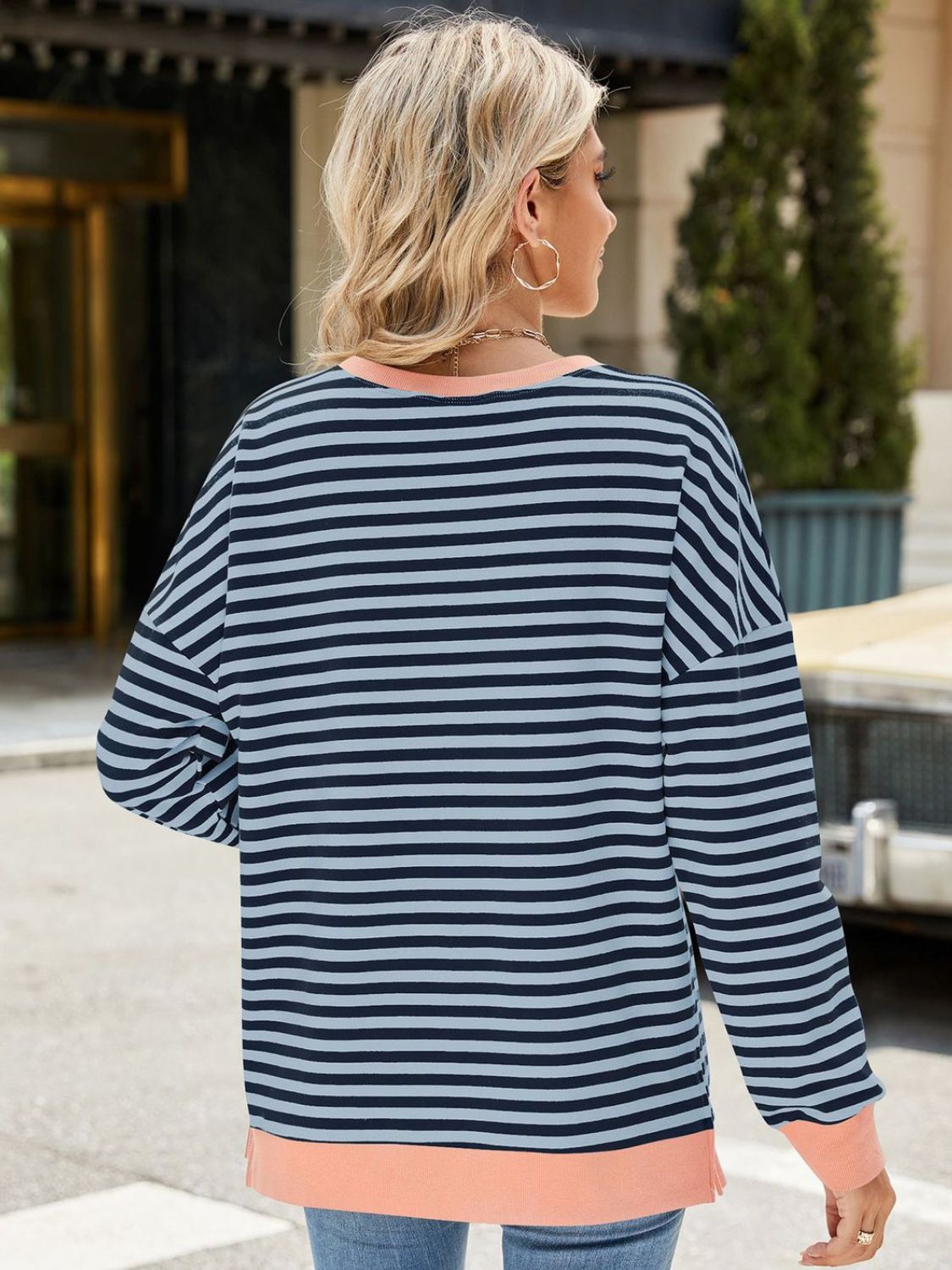 A stylish Slit Striped Round Neck Long Sleeve Sweatshirt featuring a trendy slit design, soft fabric, and available in various sizes.
