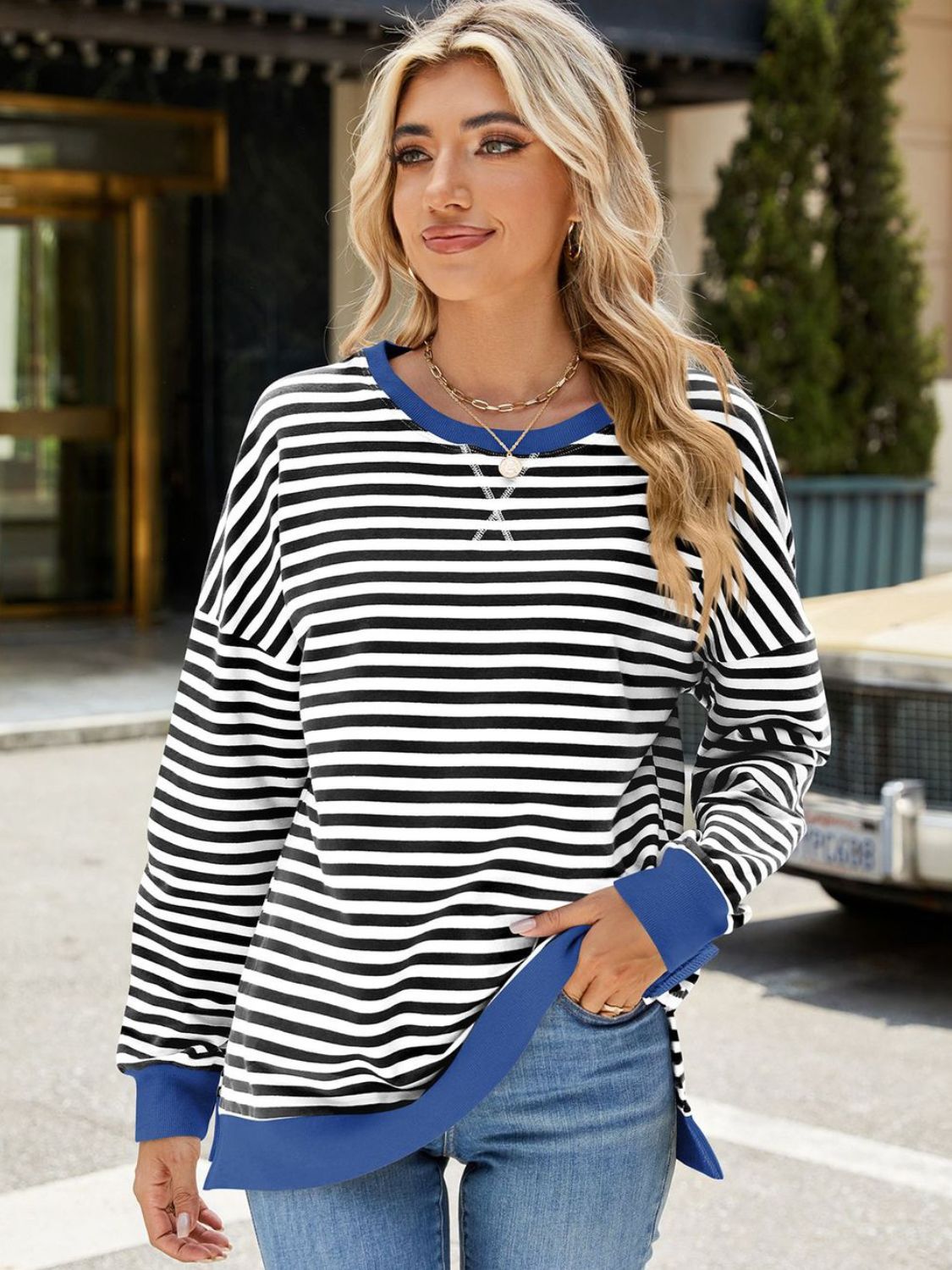 A stylish Slit Striped Round Neck Long Sleeve Sweatshirt featuring a trendy slit design, soft fabric, and available in various sizes.