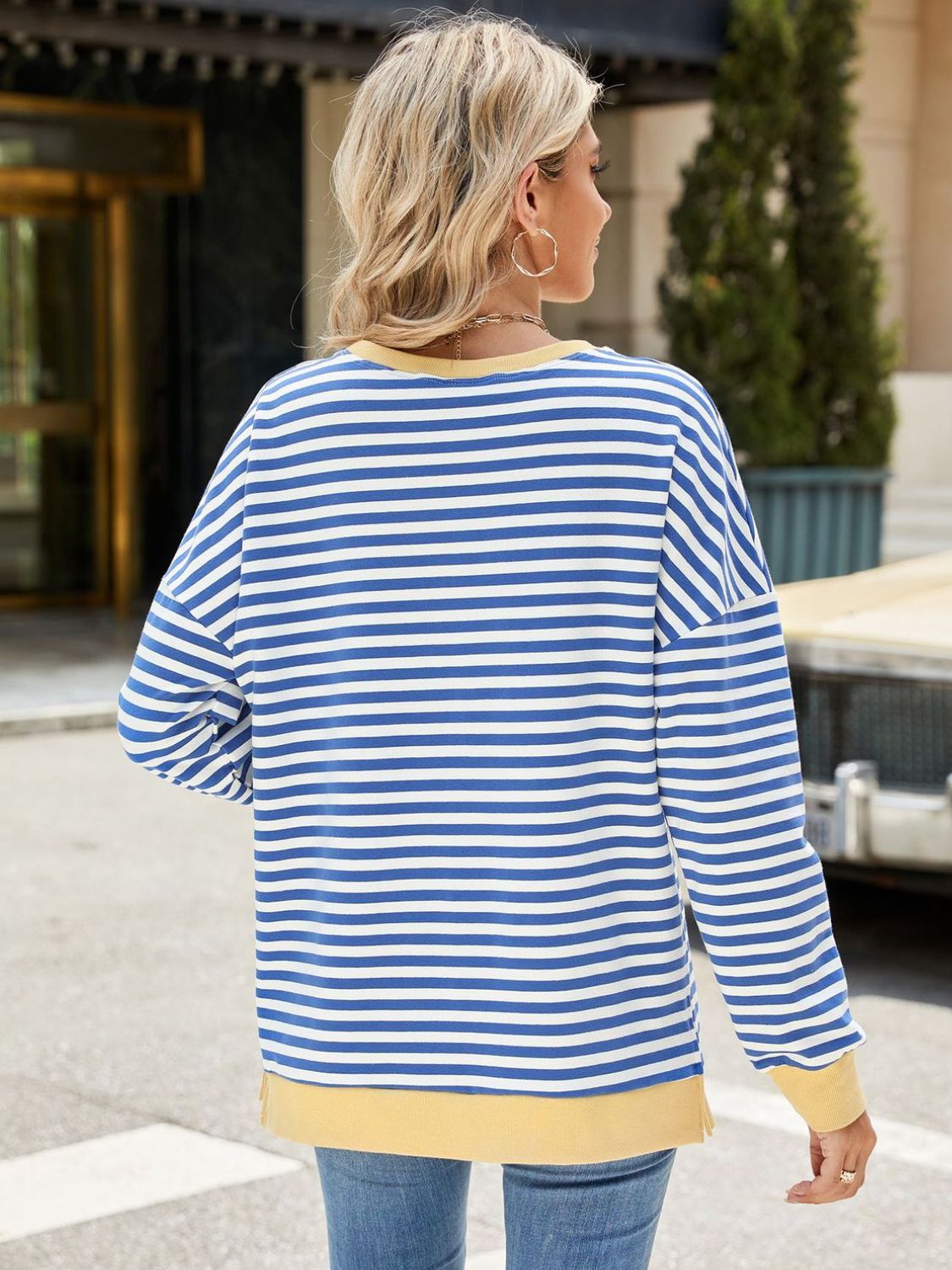 A stylish Slit Striped Round Neck Long Sleeve Sweatshirt featuring a trendy slit design, soft fabric, and available in various sizes.