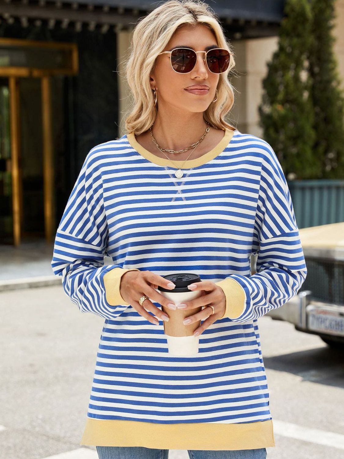 A stylish Slit Striped Round Neck Long Sleeve Sweatshirt featuring a trendy slit design, soft fabric, and available in various sizes.