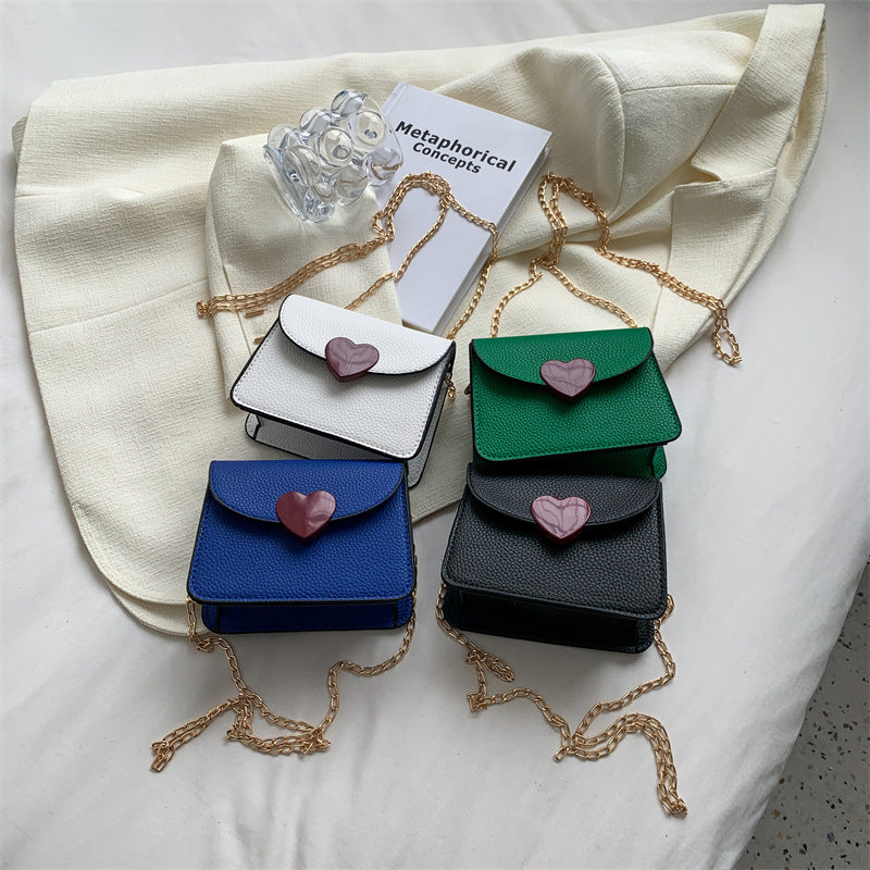 Small women's trendy mini blue messenger bag with a stylish design and zipper pocket.