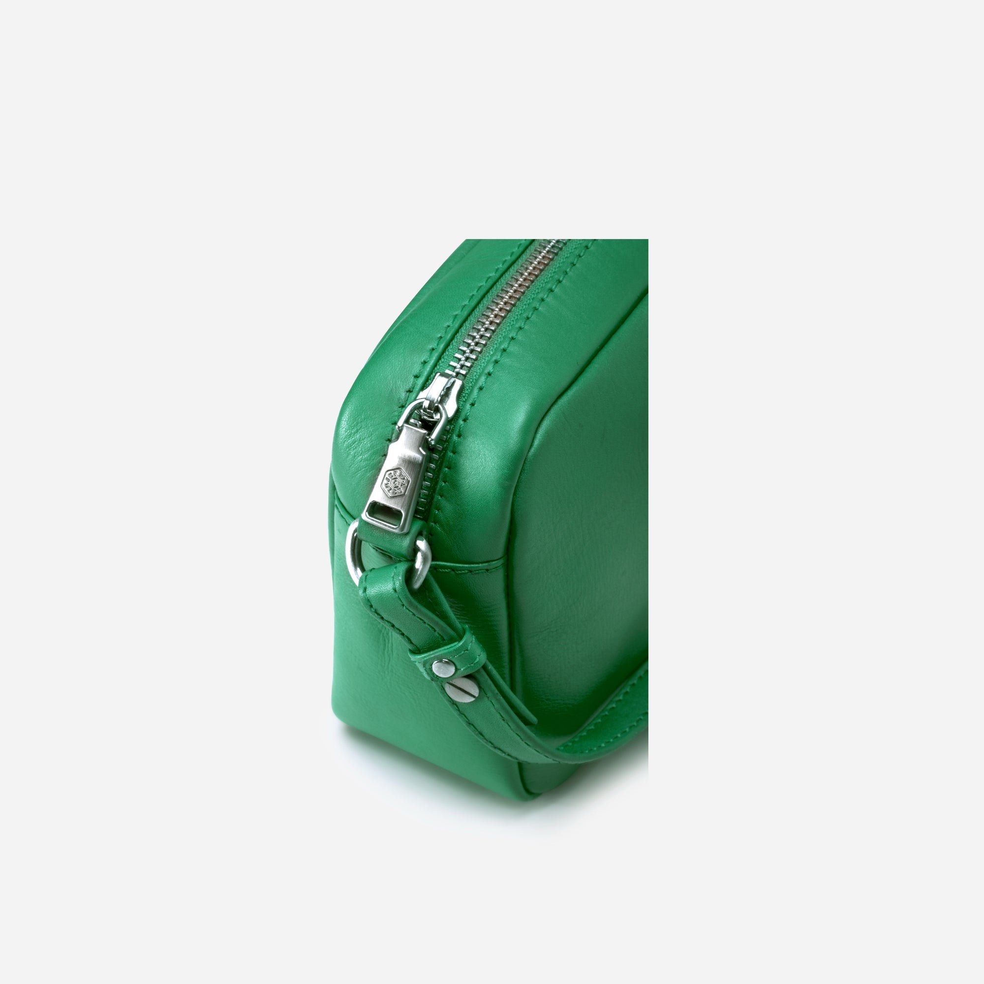 Small Crossbody bag in Spring Basil color with vibrant lining, showcasing its sleek design and spacious interior.