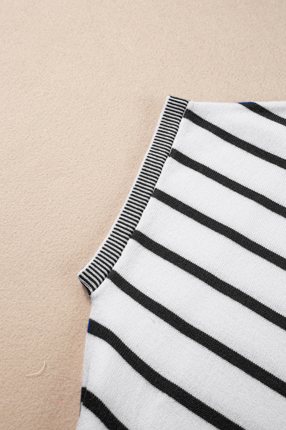 Striped round neck cap sleeve knit top in a stylish design, showcasing its soft fabric and comfortable fit.