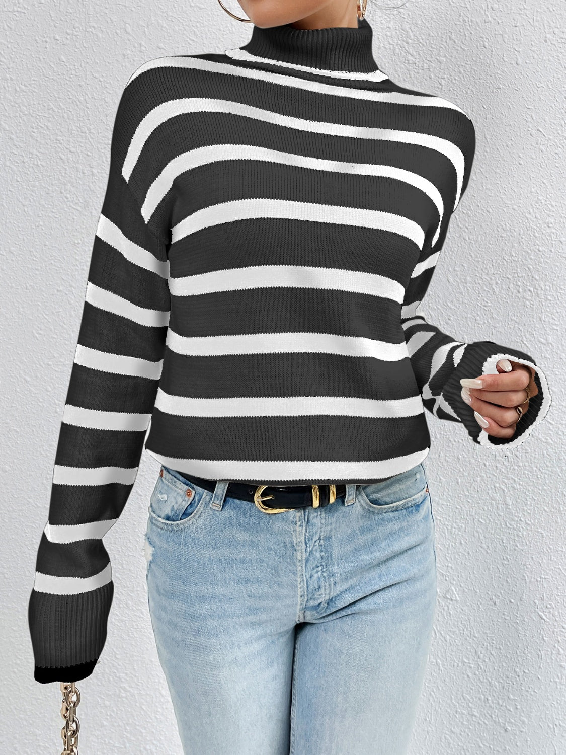 A stylish striped turtleneck drop shoulder sweater in soft fabric, showcasing its relaxed fit and trendy design.