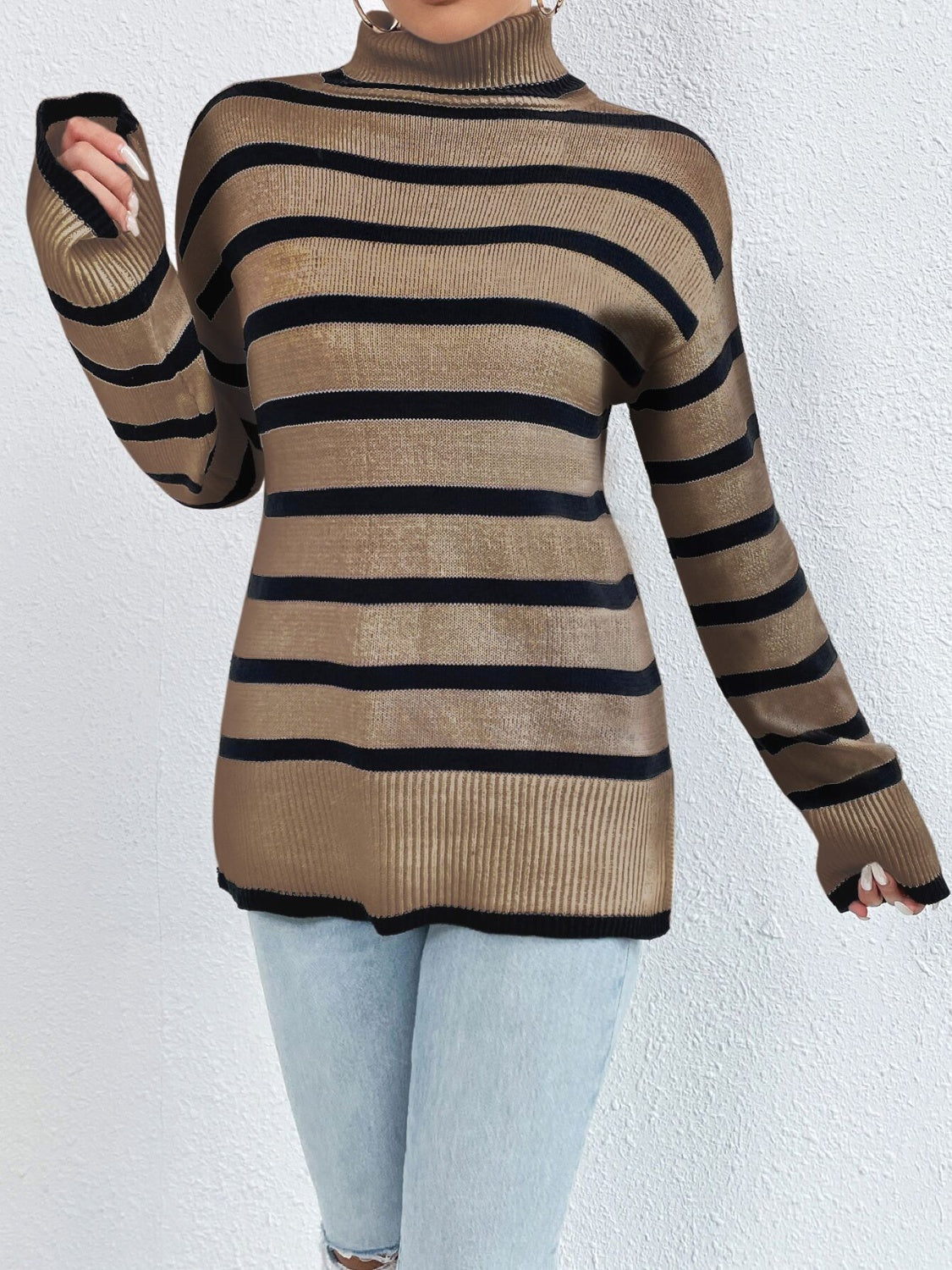 A stylish striped turtleneck drop shoulder sweater in soft fabric, showcasing its relaxed fit and trendy design.