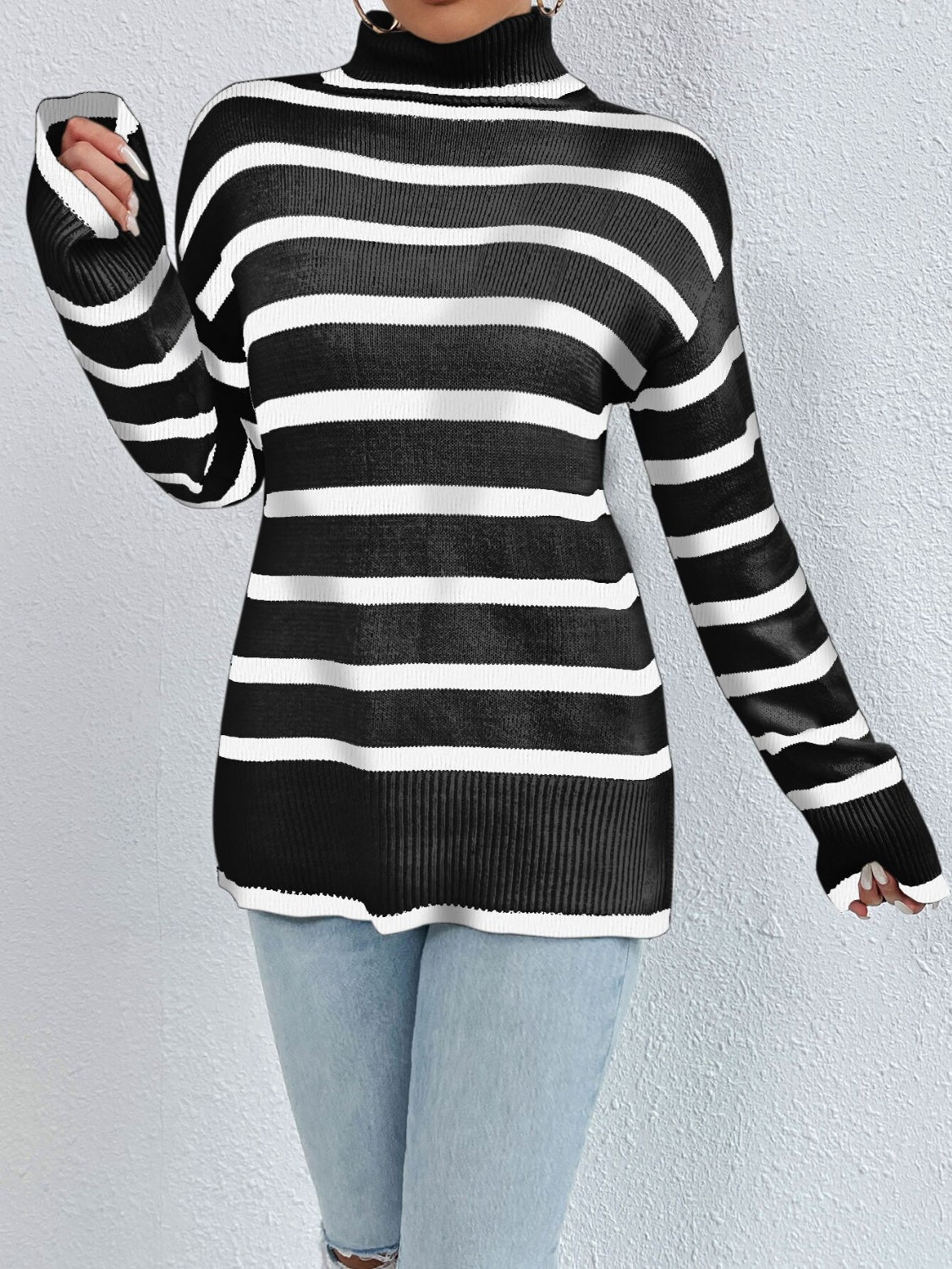 A stylish striped turtleneck drop shoulder sweater in soft fabric, showcasing its relaxed fit and trendy design.