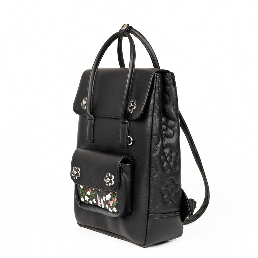 Sunny Day Backpack made from recycled PVC fabric with transparent acrylic flowers and a quilted back for comfort.