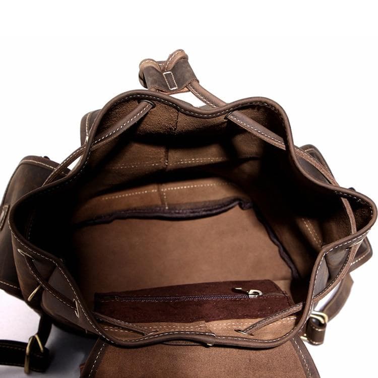 The Asmund Backpack, a genuine leather rucksack featuring a rugged design, adjustable straps, and multiple storage pockets, perfect for adventures.