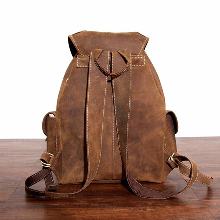 The Asmund Backpack, a genuine leather rucksack featuring a rugged design, adjustable straps, and multiple storage pockets, perfect for adventures.
