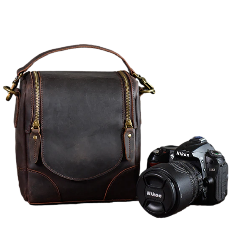 The Calista small leather camera bag made from full-grain leather, featuring a zippered back pocket and adjustable shoulder strap.