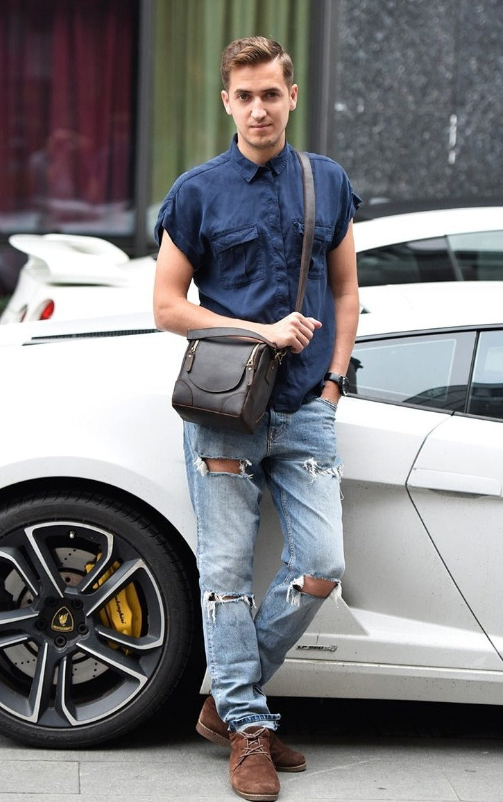 The Calista small leather camera bag made from full-grain leather, featuring a zippered back pocket and adjustable shoulder strap.