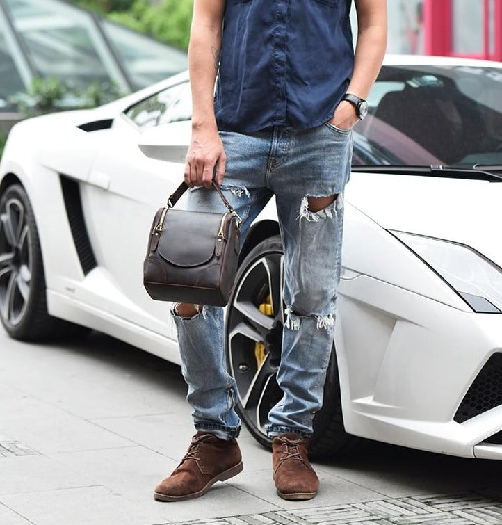 The Calista small leather camera bag made from full-grain leather, featuring a zippered back pocket and adjustable shoulder strap.