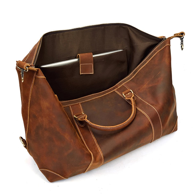 The Eira Duffle Bag made of premium crazy horse leather in two shades of brown, showcasing its spacious design and comfortable leather handles.